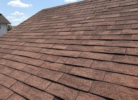 Close-up of brown architectural asphalt shingle roof on a residential home